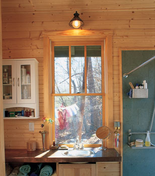 With a hot water recirculating system, Michael Chandler and Beth Williams get warm water—and a warm bathroom—when they want it. Their pipes snake around the bathroom, and a pump keeps the warm water moving.